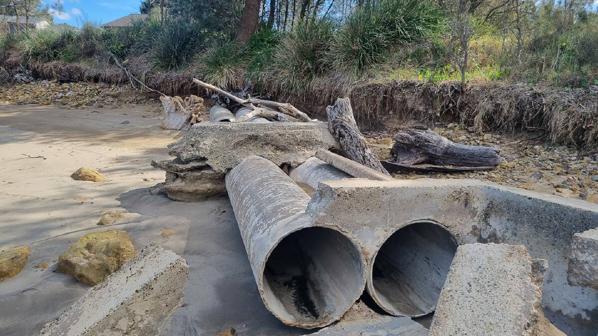 Coastal erosion and big swells have exposed stormwater pipes and slabs at Surfside beach that contain asbestos. Picture by Eurobodalla Shire Council