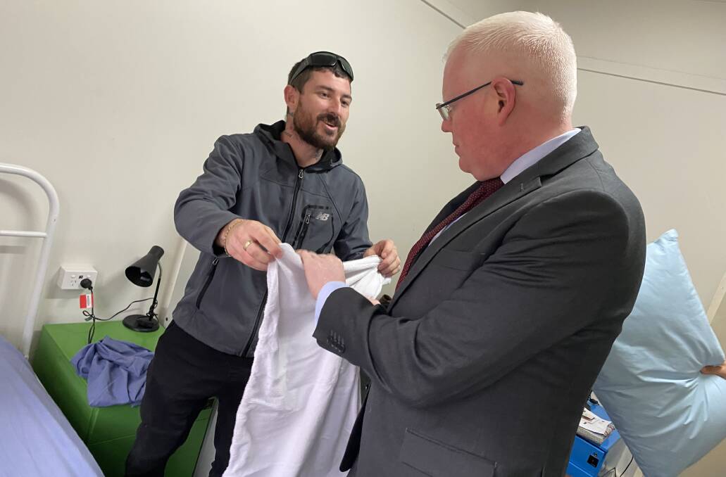 State Member for Kiama, Gareth Ward (right) helps Salt Care manager of temporary accommodation, Daniel Laughton, make up a bed to house someone who would otherwise be homeless, in Nowra's Safe Shelter building.