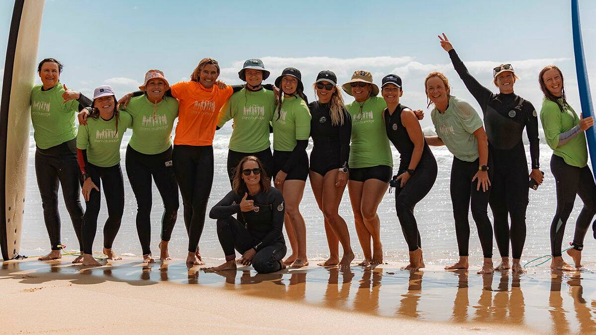 Former world surf champion, Pam Burridge, and participants of the Australian Defence Force women's surf development camp in Ulladulla. Picture by ABIS Jasmine Moody