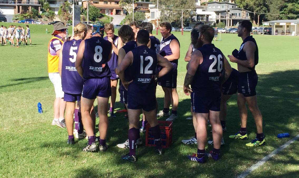 Never say die: Dockers listen to instructions during a quarter-time break. Photo: COURTNEY WARD
