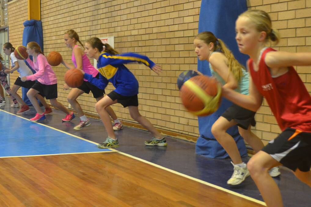 OFF TO THE RACES: The Milton Ulladulla Dolphins' under 12 girls head off down court in a speed dribbling drill, with their right hands.