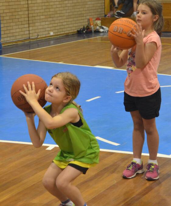 SHOOTING STARS: Charlotte Pakes sets herself for a shot, while Zara Neil watches on, at the annual “Junior All-Star” day.