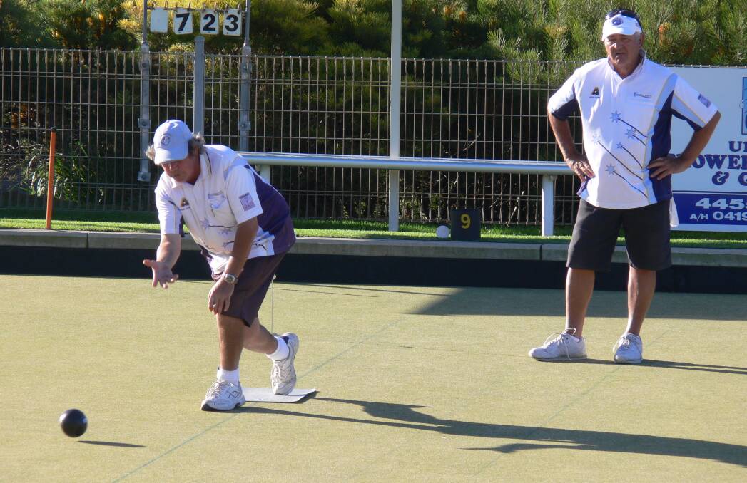 Good start: Graeme Carriage delivers another bowl as opposing skip John Ruggiero looks on in the Milton Ulladulla Men’s Triples final.
