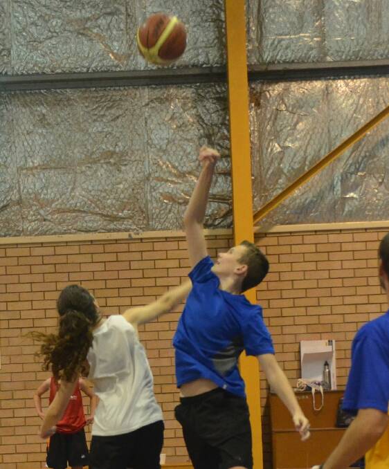 JUMP BALL: Chloe Dadd and Jonathon Taylor both spring in to the air to try and claim the ball for their team.