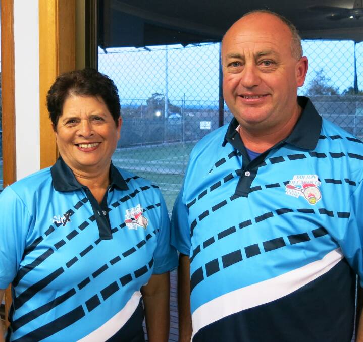 DESIGN: Committee members Pauline McIlveen and Andrew Phillips wearing the new club polo shirts. There are samples on display in the clubhouse for members to view.