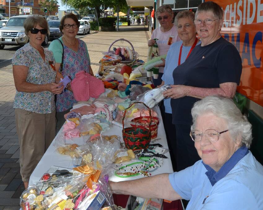 STREET STALL: Hospital auxiliary members Narelle Ober (front), Margaret Minns, Judy Shaw, Margaret Gibson, Jane Hawkins and Faye Chandler raising funds for the new renal unit.