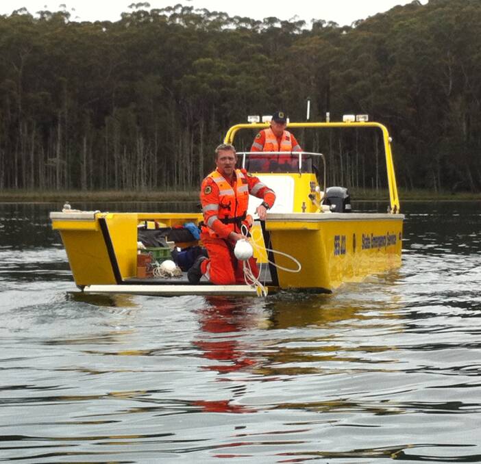 FLOOD READY: Ulladulla SES volunteer floodboat captains Bill McInnes and Wayne Firman collecting the buoys used to mark a driver training course for the unit's two new captains.