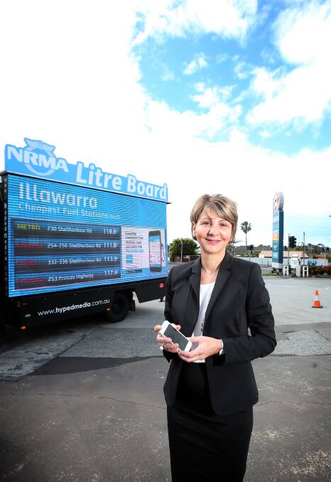 lower prices: NRMA Illawarra director Marisa Mastroianni with the "Litre Board", which lists the cheapest petrol in the Illawarra. Pictures: Sylvia Liber