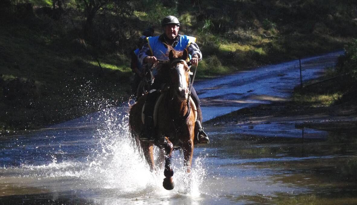 MAKE A SPLASH: Peter Norman tackles one of the creek crossings on his mare Paris during the 80 kilometre event at the Currowan Endurance Ride in 2016. Photo: Animal Focus.