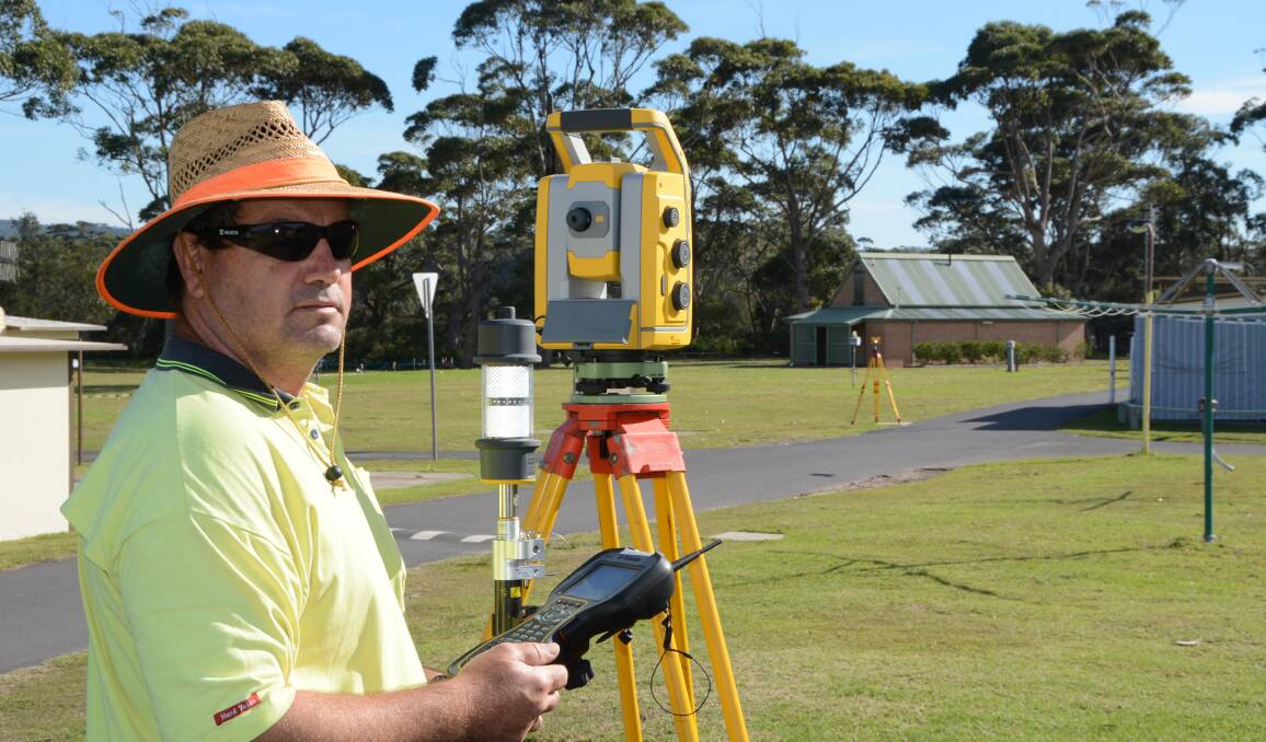 EYE LEVEL: Engineering surveyor Barry Jeffery spent several days mapping the high and low points of Holiday Haven at Lake Tabourie to help plan flood mitigation works.