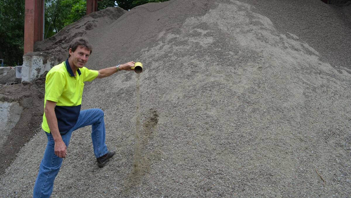 Shoalhaven Recycling project manager Stephen Willis shows how broken glass can be recycled into a sand-like product used in local construction works. Photo: Jessica Long