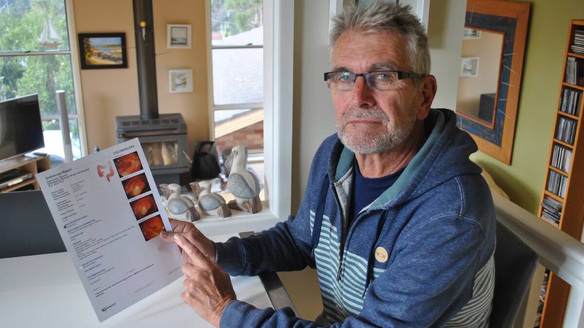LIFESAVER: Peter Gilberd with a copy of his scans showing his bowel cancer. 