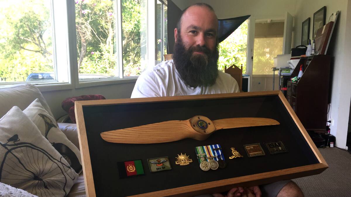 HONOUR: Ash Wilke with a display of his medals. 