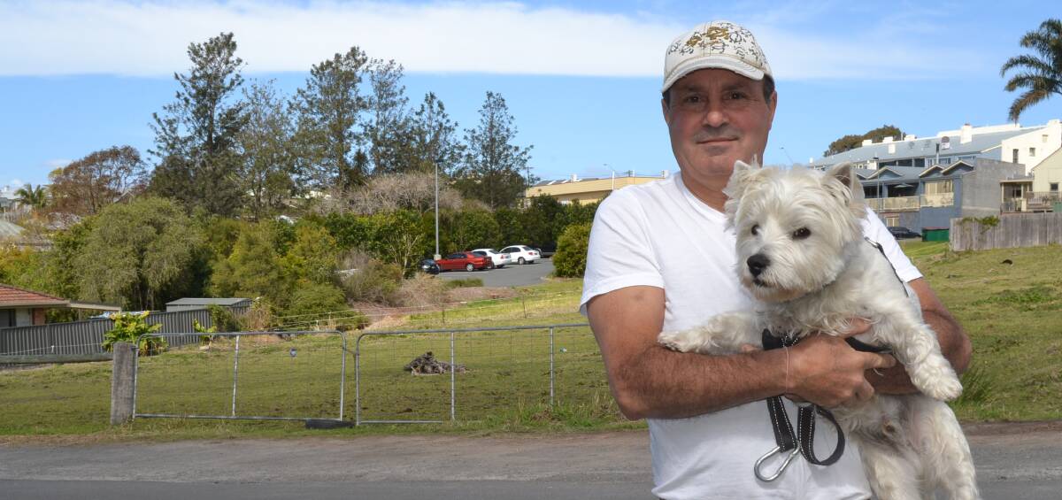 GREEN SPACE NEEDED: Milton resident Peter, with his dog Carlo, believes the land at the corner of Wason and Thomas streets should be used for a park, not parking.