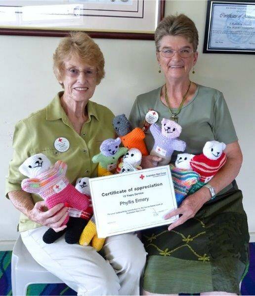 RED CROSS VOLUNTEERS: Phyllis Emery with President Margaret Peppitt showing off the trauma teddies the ladies have made. 