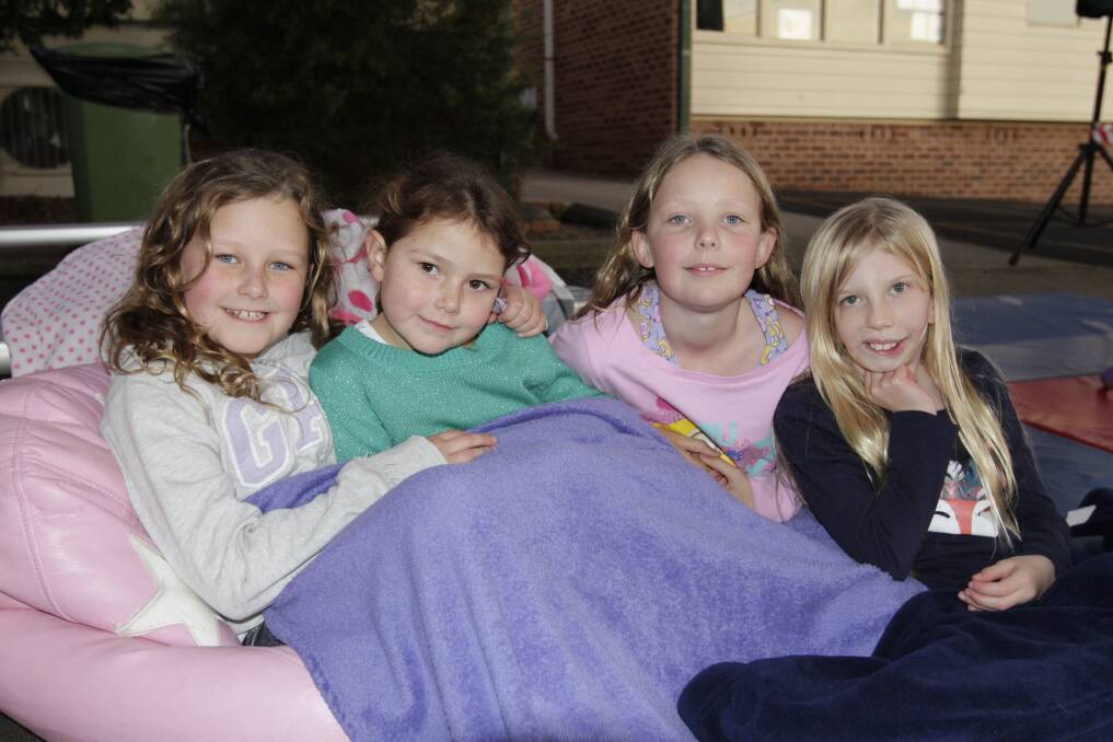 UNDER THE STARS: Mia and Ava Garrahy, Charlotte Carter and Sophie Holleley snuggle in at last year's movie night.