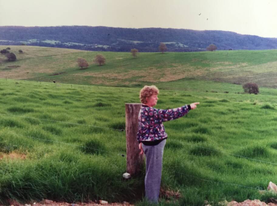 GRASSY: Anna Looks out at their new land before it was landscaped into today's garden.