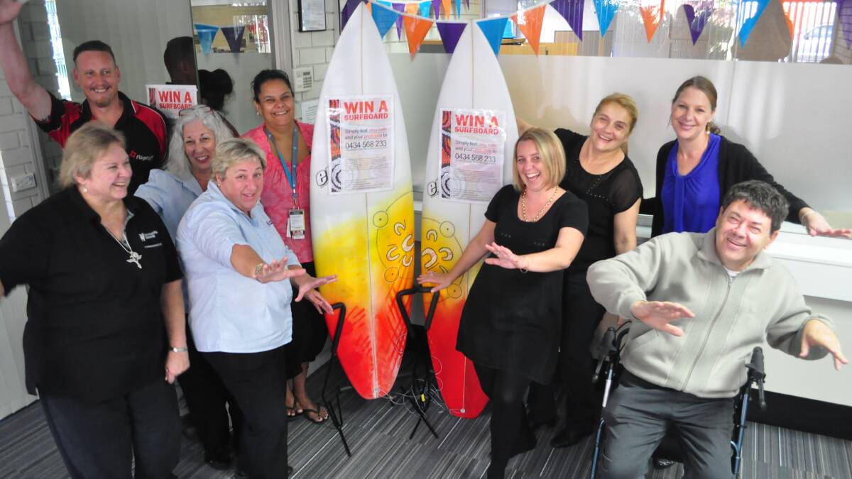 HEALTH FIRST: Jono Donald from Flagstaff Group, Susan Moore, Rhonda Parker and Sue Kuebler from Community Gateway, Natalie Beckett from HARP Unit (HIV AIDS related team), Brooke Gould, Lily O'Connor and Jacqui Dalziel from Community Gateway and client Keith Chamberlain at the surfboard display at Community Gateway Hub on Berry Street on Monday morning.