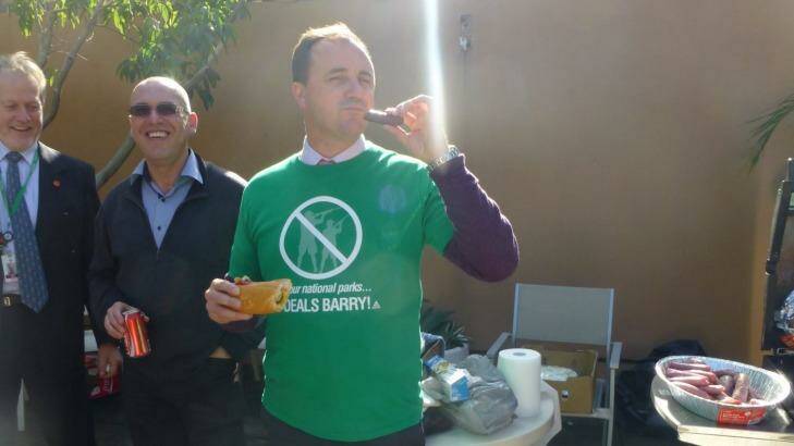 NSW Greens MP Jeremy Buckingham eats a "freshly-hunted" sausage at a barbecue in 2013. Photo: Shooters, Fishers and Farmers Party
