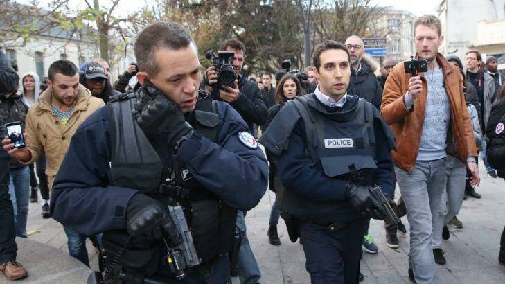 Journalists film police arriving at the scene of the shootout in Saint-Denis on Wednesday. Photo: Andrew Meares