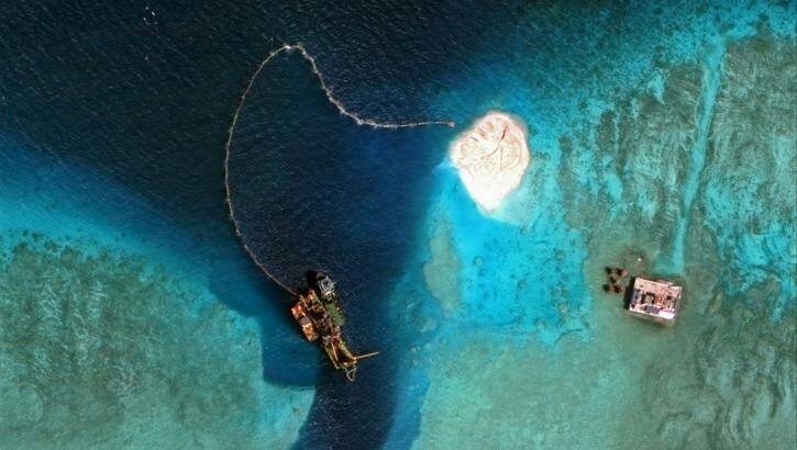A dredger operates at the southern entrance to the Mischief Reef. China says new islands in the disputed South China Sea will provide military defence and civilian services. Photo: CSIS Asia Maritime Transparency Initiative