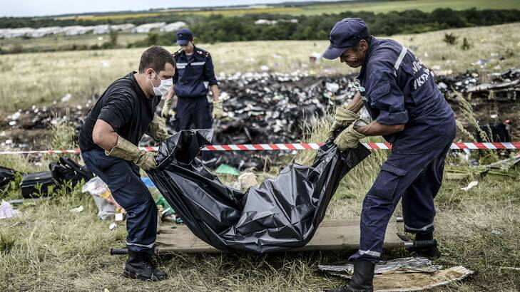 Ukrainian emergency workers collect the body of a victim at the MH17 crash site near Grabove, in rebel-held east Ukraine. Photo: AFP Photo
