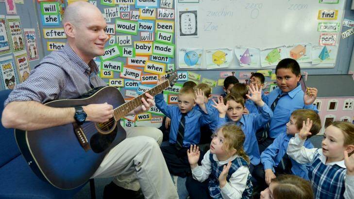 Rocking on: Dan Colquhoun whose songs are a big hit on YouTube, gets students into the swing of things at St Declan's Catholic Primary School.  Photo: Catholic Education Office