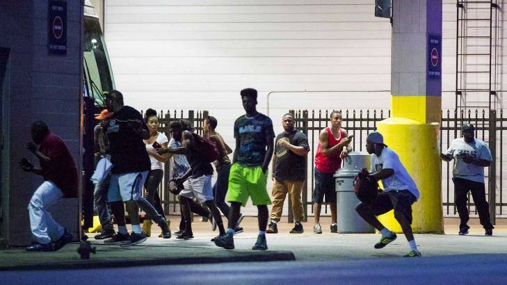 Bystanders run for cover after shots fired at a Black Live Matter rally in downtown Dallas. Photo: Smiley N. Pool
