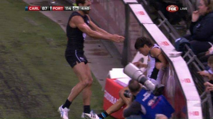 Round one: Andrew Walker throws Angus Monfries into the fence. Photo: Fox Footy
