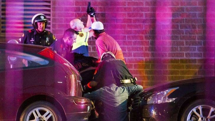 Dallas Police shield bystanders after shots are fired. Photo: Smiley N. Pool/The Dallas Morning News