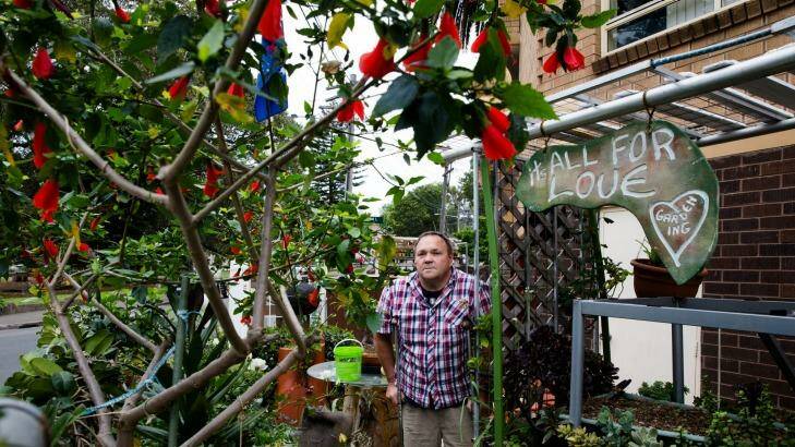 David Bath in the garden he built to try to improve the area around a social housing block in Alexandra Road, Glebe, where he lives. Photo: Edwina Pickles