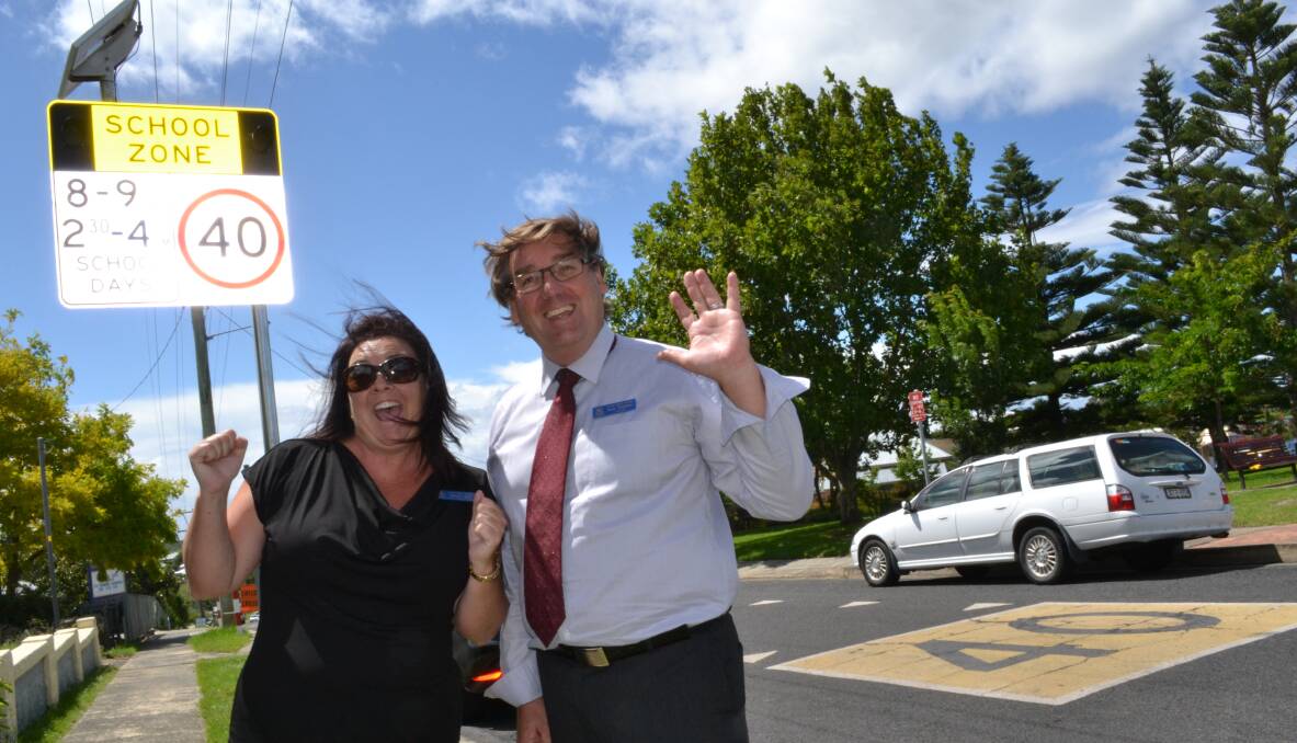 WAIT IS OVER: Milton Public School P and C president Mel Wills and principal Mark Thomson were thrilled to see flashing lights installed outside the school on Thursday, but are calling for additional drop-off zones in Thomas Street.