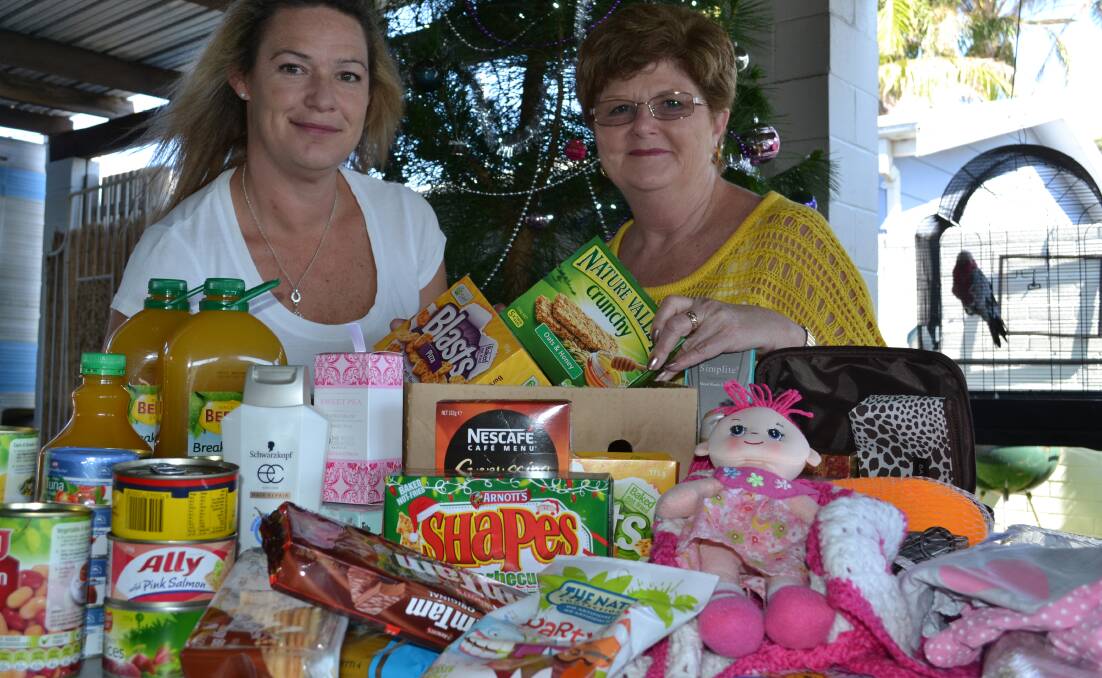 CHRISTMAS CHEER: Ulladulla Soup Kitchen volunteer Leonie Smith (left) with Kae Hilder who donated hand-made toys and a variety of food for the 15 Can Challenge family Christmas hampers.