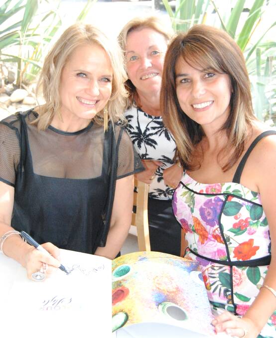 STYLE GUIDE: Maria Lavalle and Denise Wade having their copies of Design With Colour and Style signed by author Shaynna Blaze at Bannisters on Thursday.