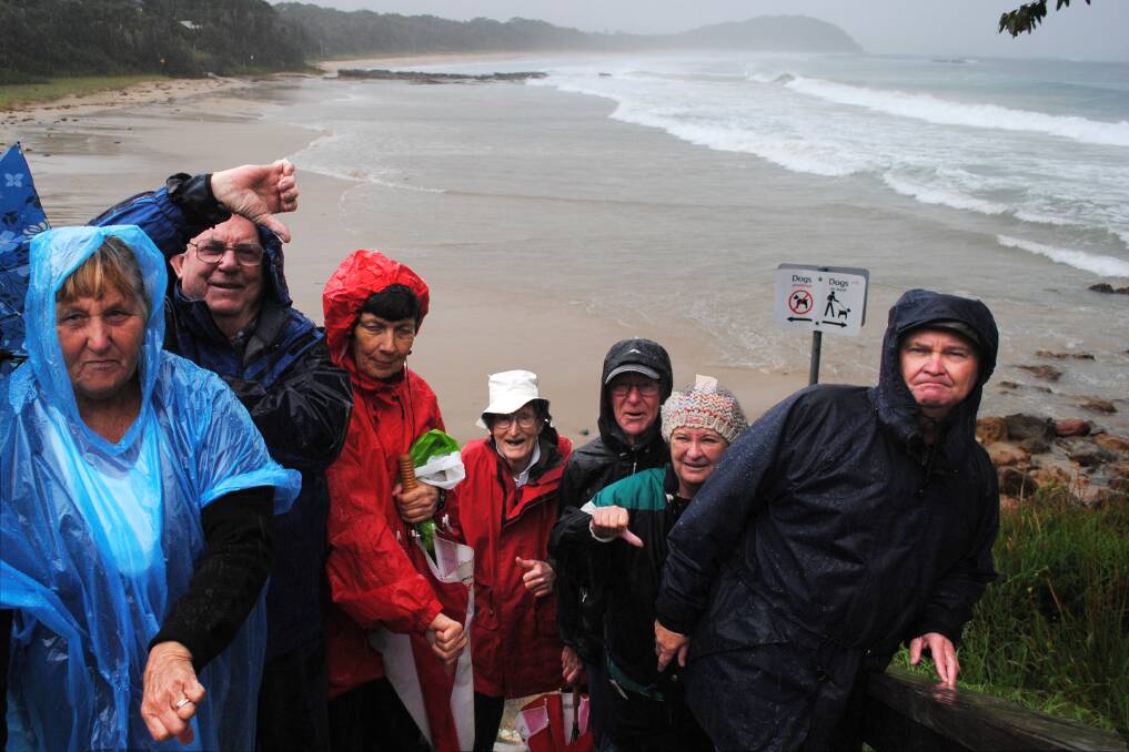 NO DOGS: Monday’s torrential rain was no dampener for a group of outraged residents who met to oppose calls for more dog zones, including an off-leash exercise area, on Narrawallee Beach. The group, including Yvonne (left) and Barry Miller, Frances Hepburn, Russell Peterson, John Hepburn, Wendy Fuller and Richard Purves have launched a counter-petition.
