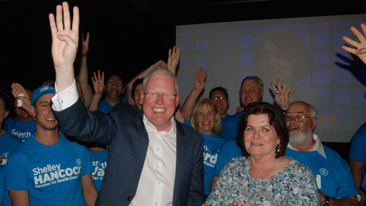 THEY'RE BACK: Surrounded by campaign workers, Gareth Ward and Shelley Hancock celebrate their win at the Bomaderry Bowling Club on Saturday night.