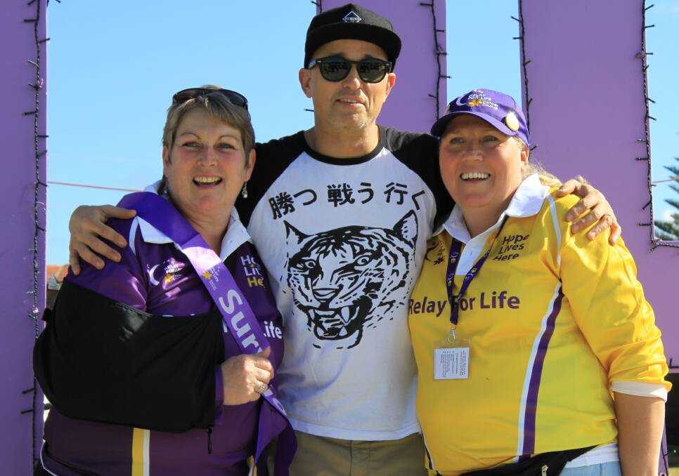 COURAGE: Cindy Wheatley (LEFT) pictured with Johnny Diesel and event coordinator Caz Boland at the 2014 relay for Life where she was awarded the Heidi Brook Memorial Award for her bravery and selfless contributions to the local community.