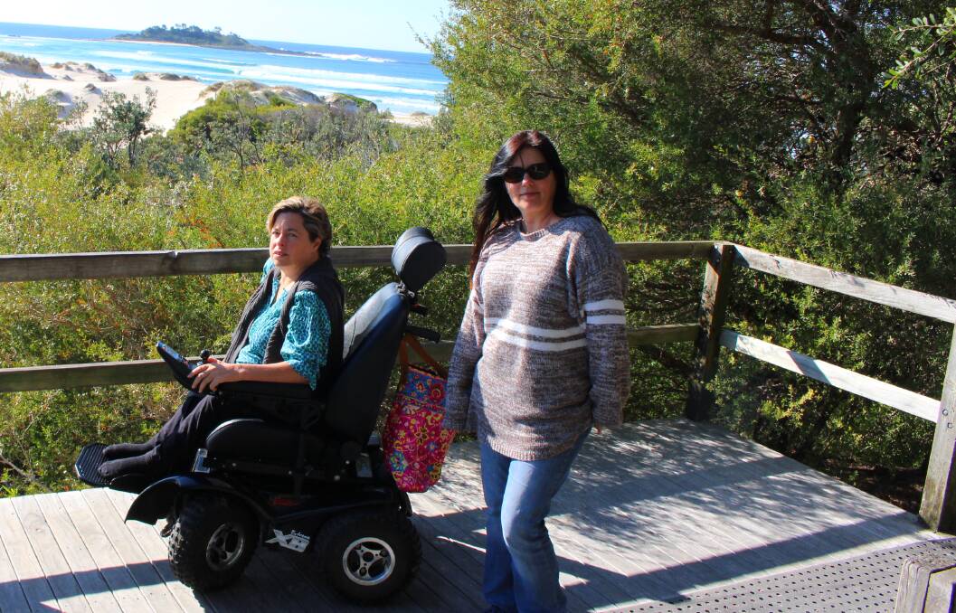 FRESH AIR: Nicky Goozee uses the Lake Conjola boardwalk to access the beach in her wheelchair and said she would be devastated if it were closed or pulled down due to a lack of funding.