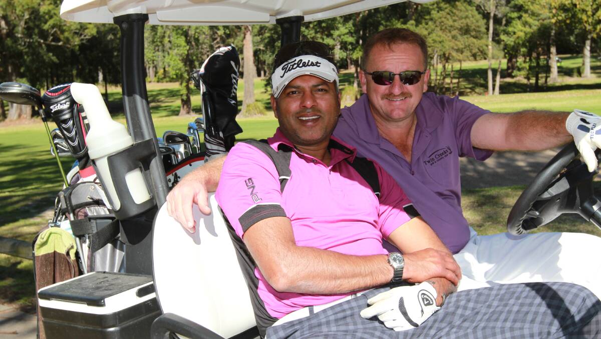 FUN TIMES: Saif Buhari and Rob Pearse from Horsley Park grab a buggy at the Mollymook Open Golf tournament. 