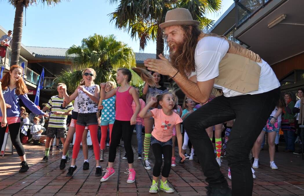 HAPPY: Tommy Franklin, dubbed the world’s happiest man, dances along with a flash mob in The Plaza at Ulladulla during the weekend’s Ulladullirious comedy festival. Photo: KATE RYAN 