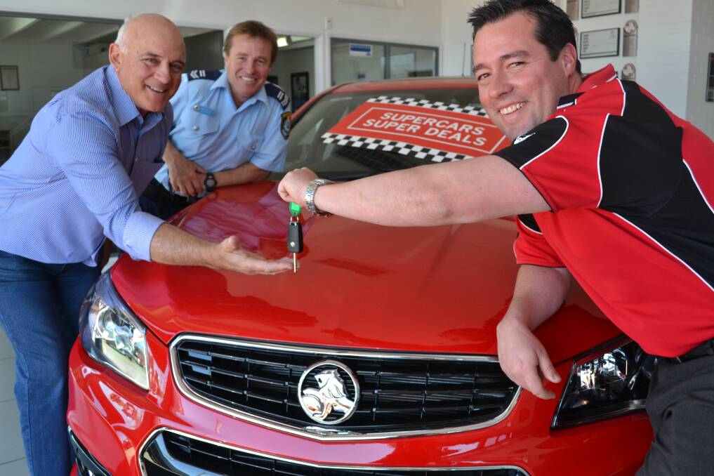 READY TO ROLL: Youth Driver Education coordinator Michael Mastronardi and police coordinator Senior Constable Adam Cooper are presented keys from Alan May Holden general manager Steven Lowe who will supply three vehicles for use by local students during the training program. 