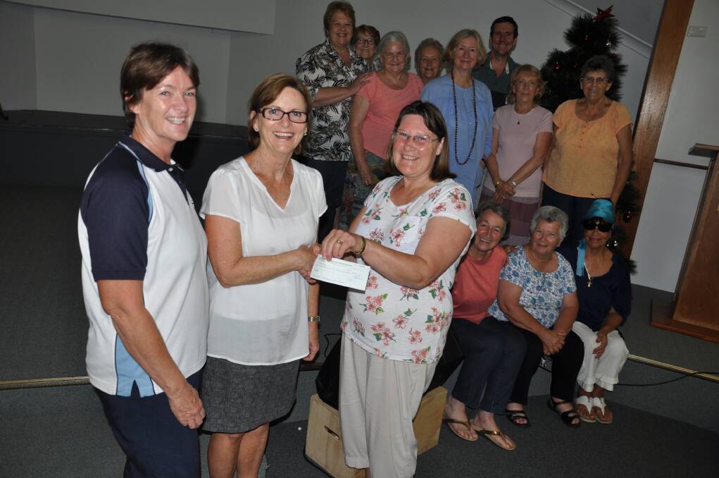 GREAT GIFT: Miltones coordinator Jenny Leyshon (foreground right) presents a check to Jindelara committee members Sylvia stone and Carol Malmo in front of some of the Miltones choir. 