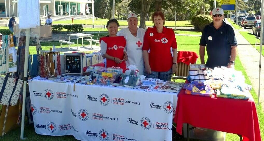 HELPING HAND: Milton Ulladulla Red Cross branch members Rose Wright, Lesley Harper, Tricia Meredith and John Wright man the Red Cross stall at the ‘Make A  Noise’ celebrations. Photo: MARGARET PEPPITT 