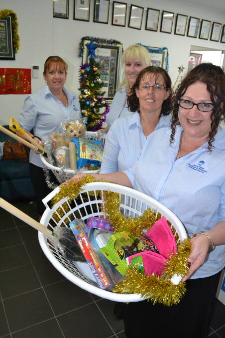 SANTA’S HELPERS: South Coast Business and Financial Solutions staff Reschenda Hawkins, Renee Menzies, Debbie Short and Fiona Bridle ask you do give a little something to a family in need this Christmas. 