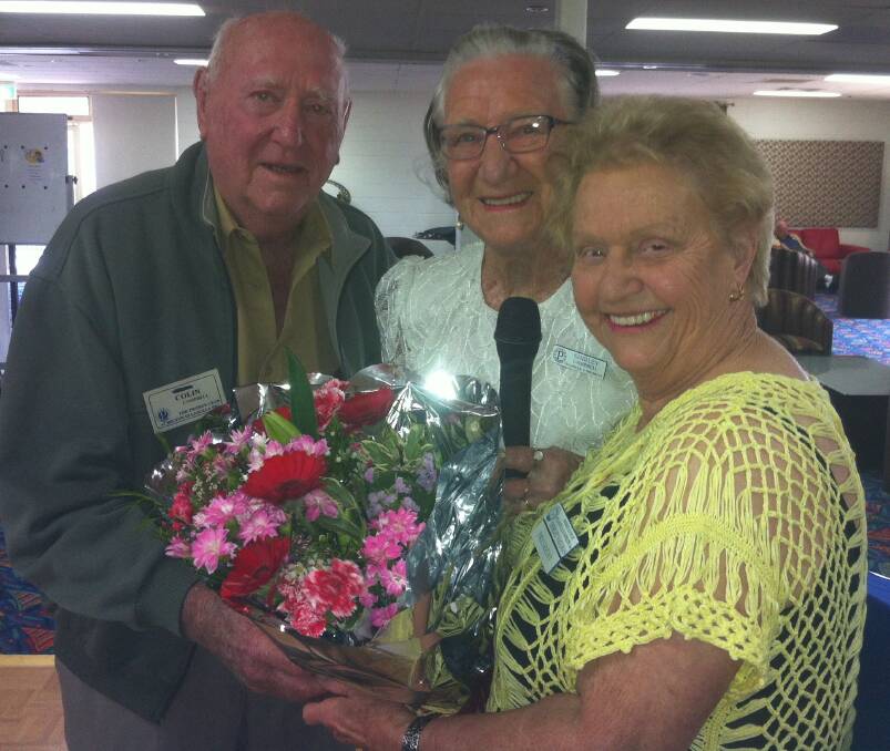 FAREWELL: Probus Club of Ulladulla and District president Shirley Vaughan (right) presents Colin and Shirley Campbell (left and middle) with flowers to wish them well with their move to ACT. 