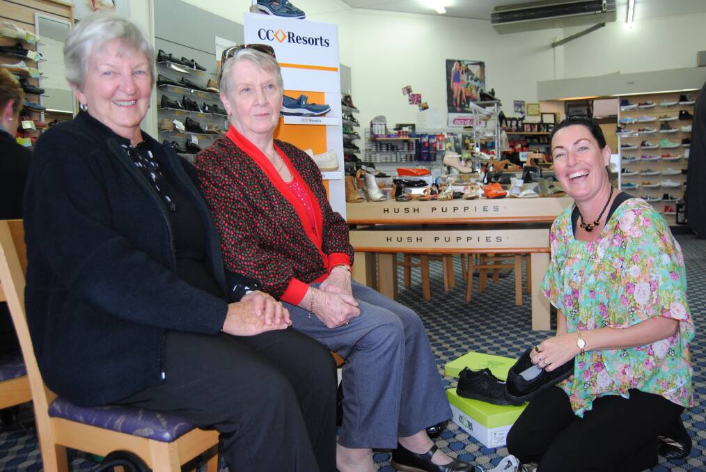 IF THE SHOE FITS: Fiona Ivers from Comfort Shoes in Ulladulla helps Eve Jones of Mollymook and sister-in-law Hilda Jones of Baulkham Hills choose shoes that have been heavily discounted as part of the MUD Markets. 