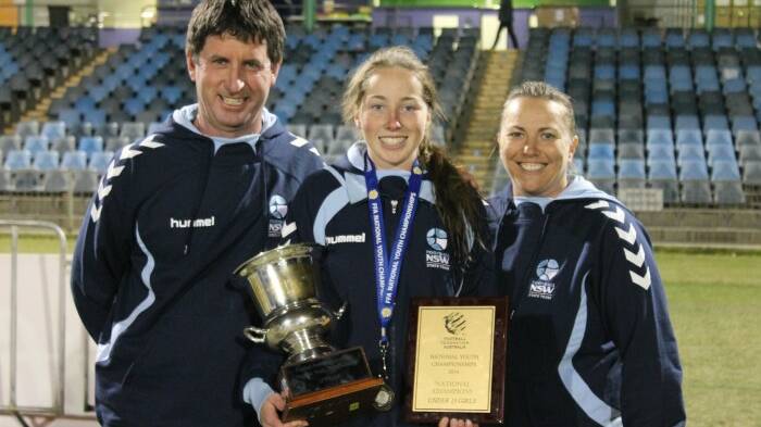 TROPHY: Andrew Mason coach, Ulladulla player Brittany Anderson holding the team’s National Trophy and Jen Todd head coach.