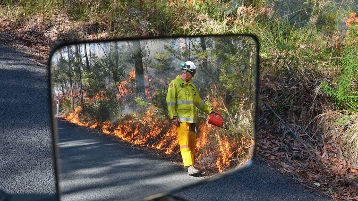 ON FIRE: NPWS officer Roger Dunn at work reducing the risk of wildfire through hazard reduction burning in the Ulladulla area. Photo: MIKE JARMAN.