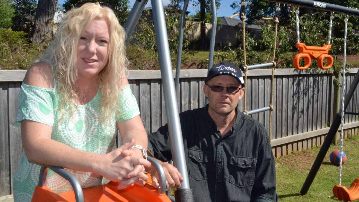 A LOT OF LOVE: Foster carers Michelle and Trevor Joyce relax in the yard of their Ulladulla home.