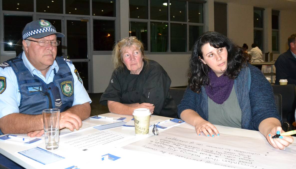 Senior Constable Tony Jory, Gayle Dunn and Lisa Gowen from Ulladulla Community Services jot down ideas for tackling the ice scourge during Wednesday night's forum organised by Federal Member for Gilmore, Ann Sudmalis.